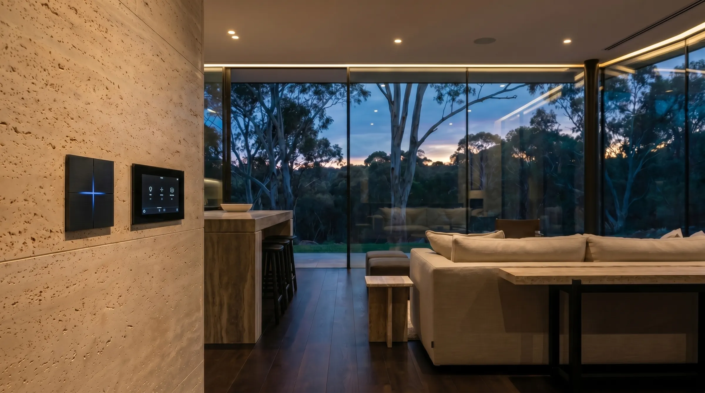 Warm cove and accent lighting layered through a living room with a real Basalte switch and touch panel