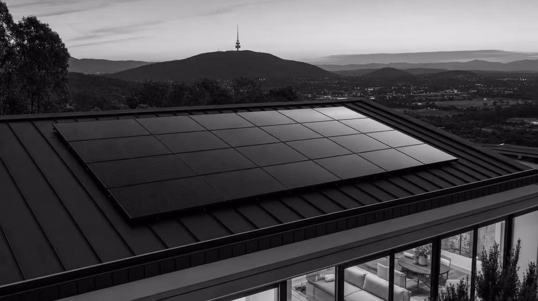 Symmetrical all-black solar array on a Canberra home at dusk